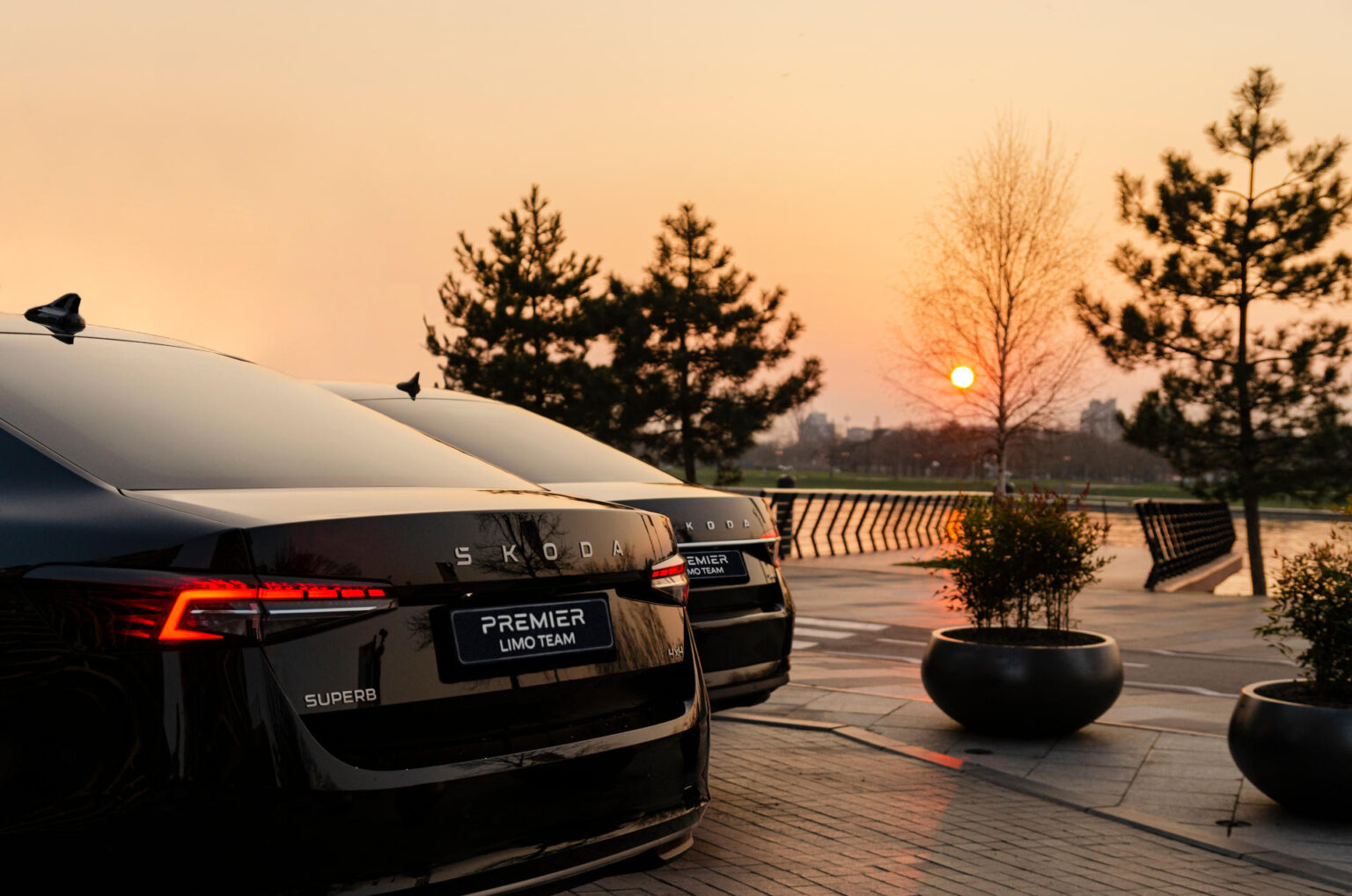 Premiere Limo Team fleet, two Škoda Superb cars parked in Belgrade sunset