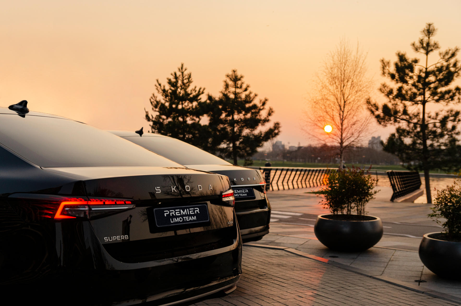 Premiere Limo Team fleet, two Škoda Superb cars parked in Belgrade sunset