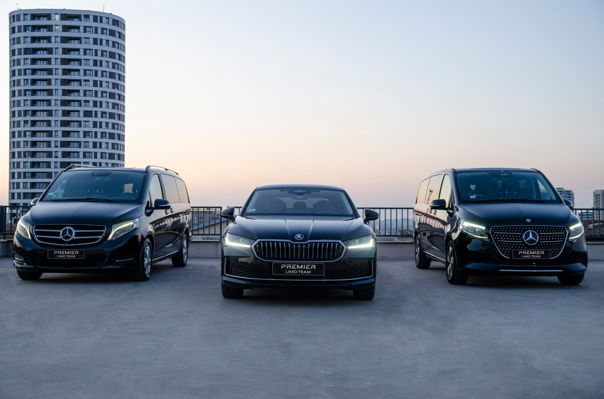 Photo of a Premier Limo Team car and two mini vans